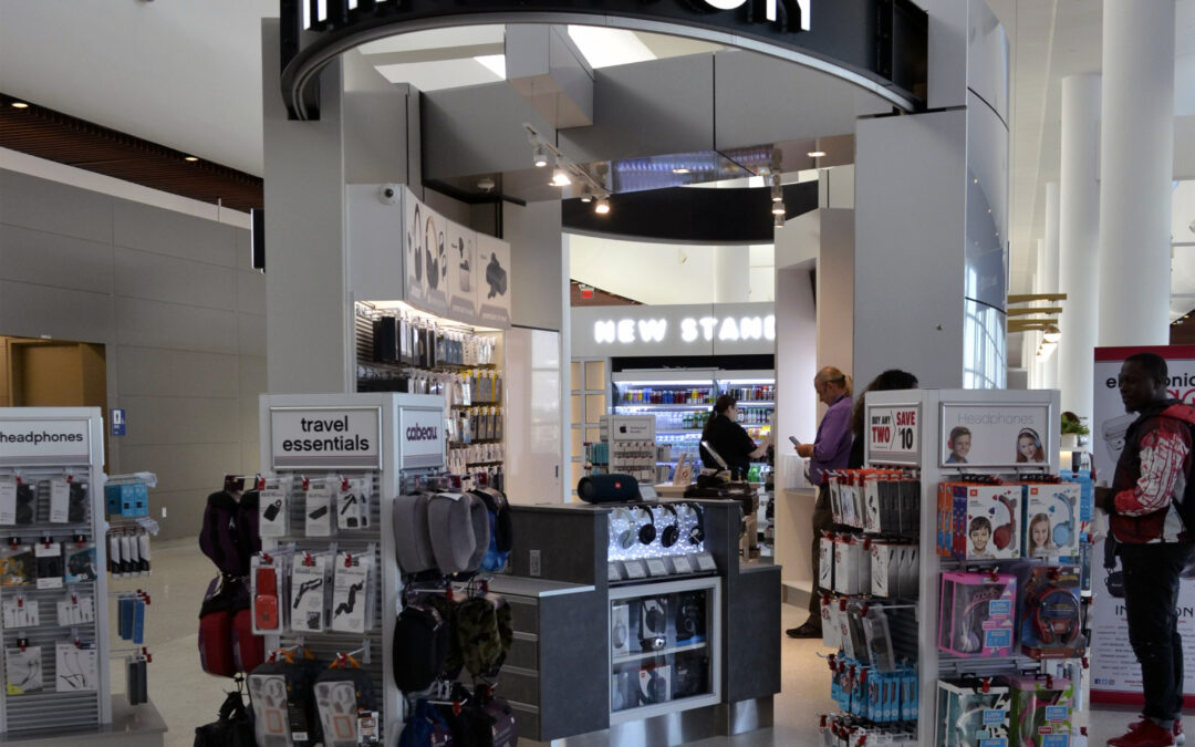 InMotion store in Concourse C Store accessories are on racks in the foreground as customers look around in the background